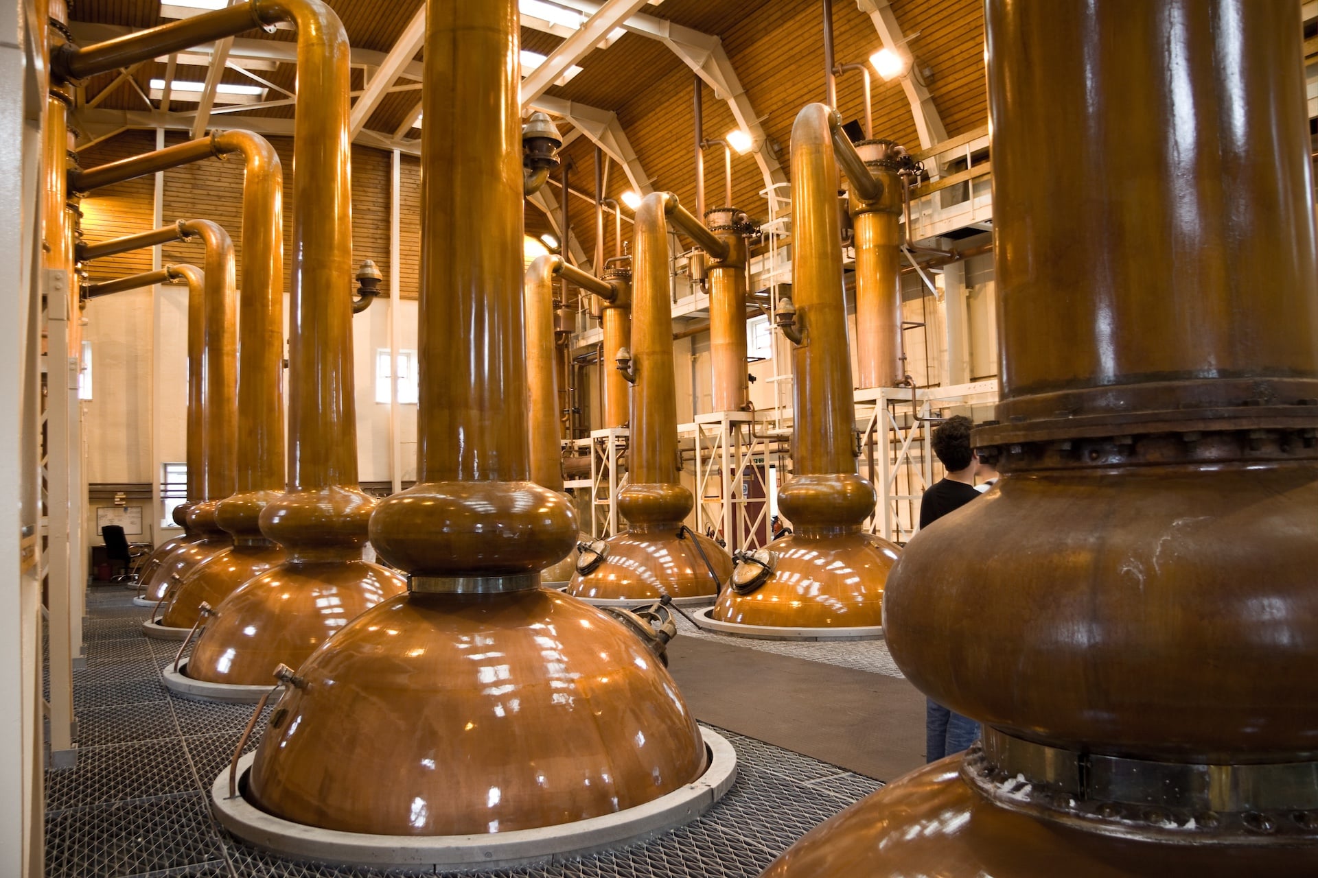 Large whiskey distills in a whiskey distillery in Scotland.
