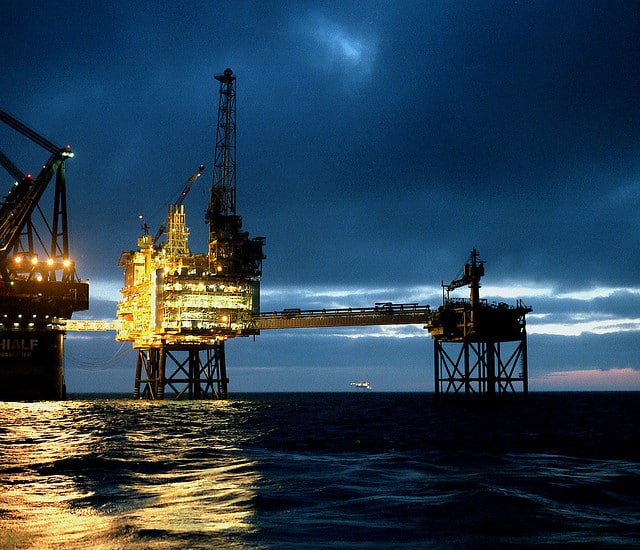 offshore oil rig lit at night