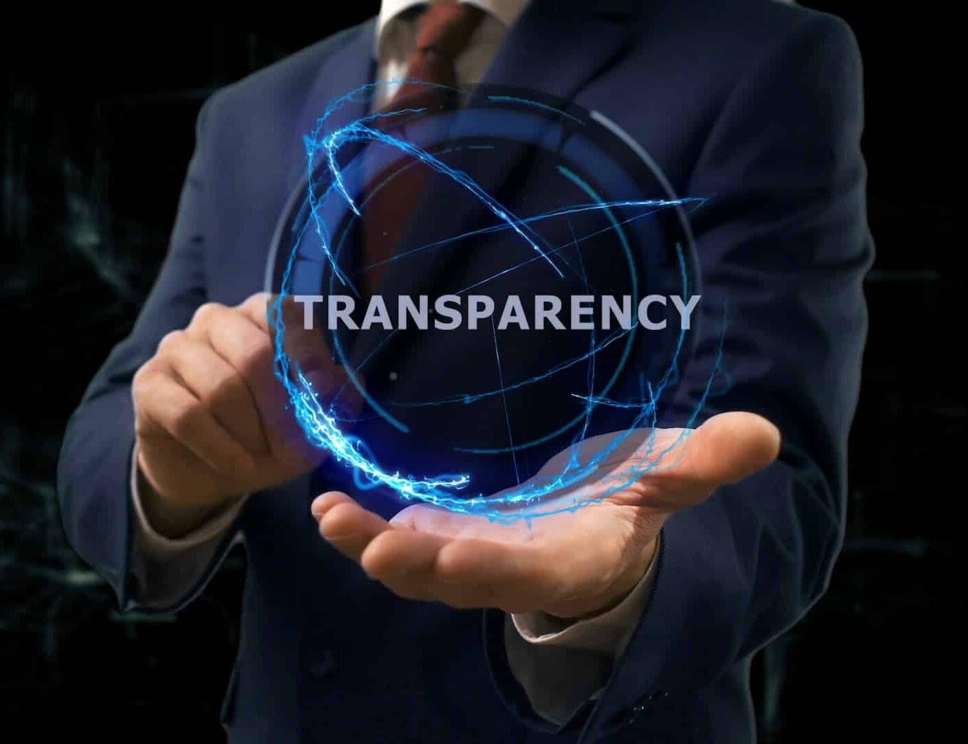 Businessman shows concept hologram Transparency on his hand. Man in business suit with future technology screen and modern cosmic background